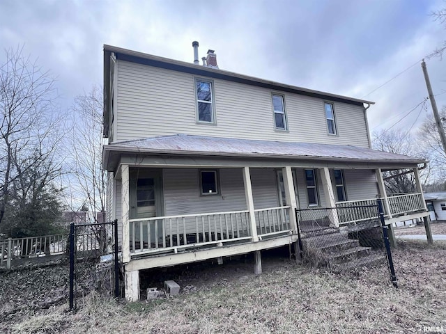 view of front of house featuring a porch and a chimney