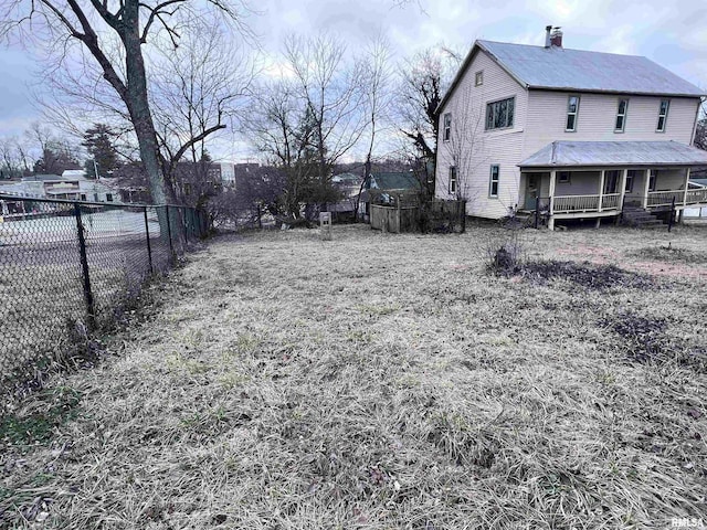 view of yard with fence and covered porch