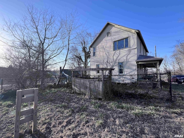 view of home's exterior with fence