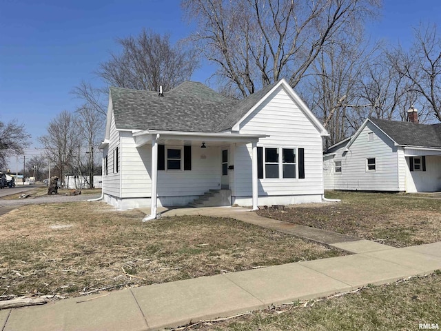 bungalow-style home with roof with shingles