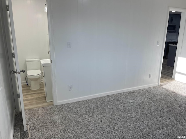 unfurnished bedroom featuring carpet, visible vents, and baseboards