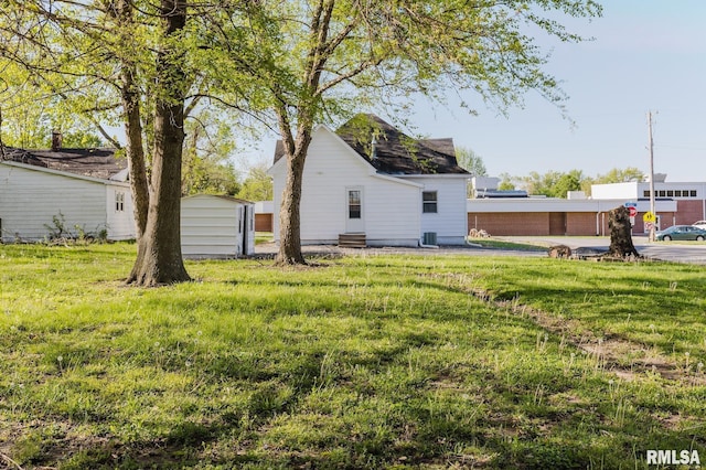 view of yard with a storage unit, an outdoor structure, and entry steps