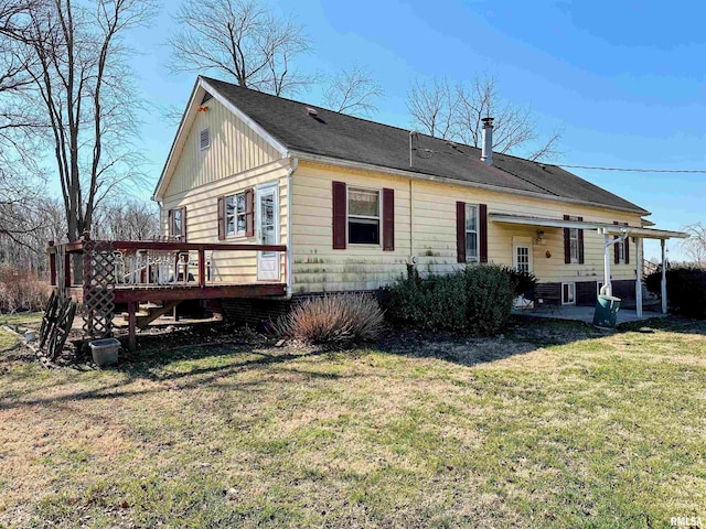 exterior space with a patio area, a deck, and a front lawn