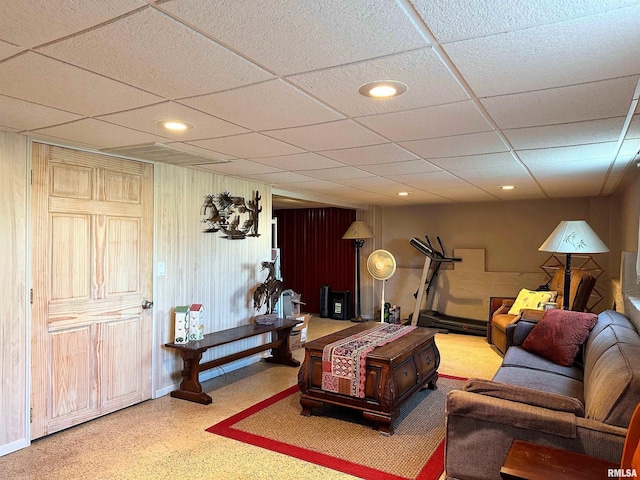 living room featuring a drop ceiling, recessed lighting, and baseboards