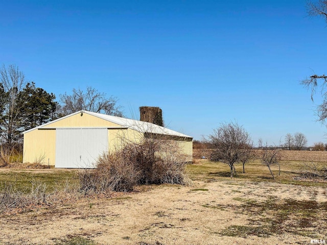 view of side of home featuring an outbuilding and a detached garage