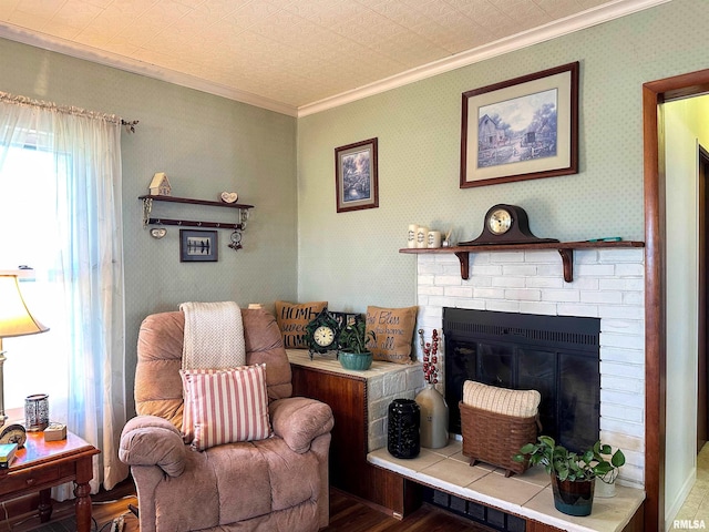 living room featuring a brick fireplace, wallpapered walls, and crown molding