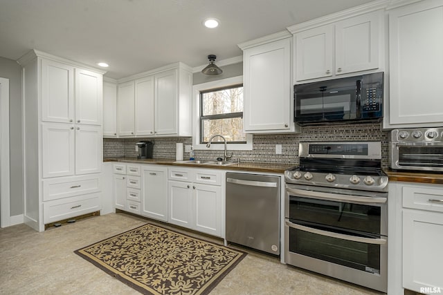 kitchen featuring a sink, stainless steel appliances, decorative backsplash, and white cabinetry