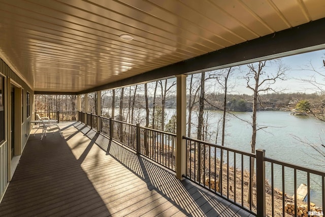 wooden terrace featuring a water view