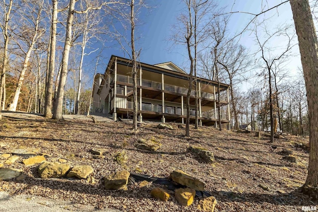 back of house featuring a wooden deck