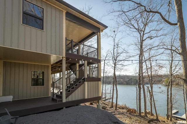 deck featuring stairway and a water view