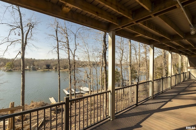 wooden deck featuring a water view and a boat dock