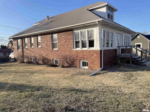 view of property exterior featuring a yard and brick siding