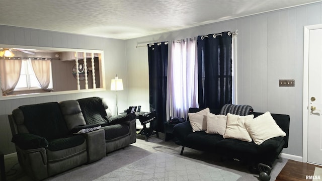 living area with a textured ceiling and wood finished floors