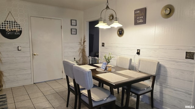 dining area with light tile patterned floors and radiator heating unit