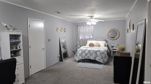 carpeted bedroom with ceiling fan and ornamental molding