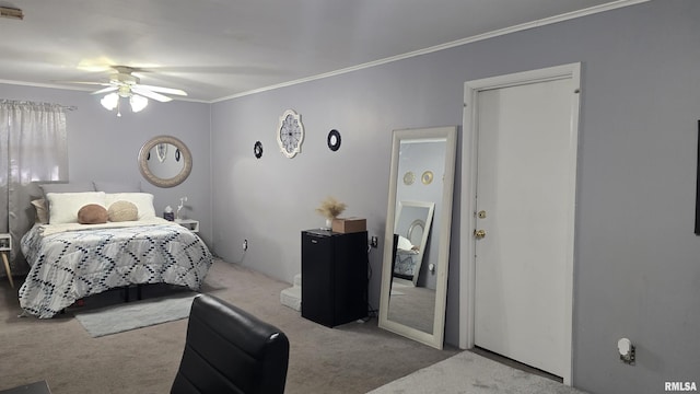 carpeted bedroom with visible vents, crown molding, and a ceiling fan