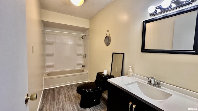 full bath with washtub / shower combination, toilet, vanity, and wood finished floors