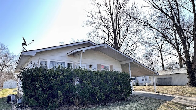 view of side of home featuring concrete driveway