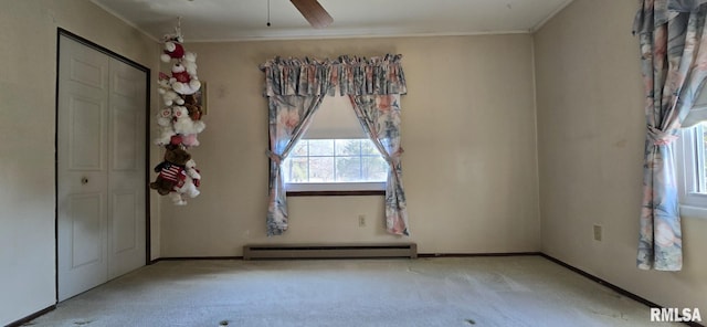 unfurnished bedroom featuring ornamental molding, a closet, carpet flooring, baseboards, and baseboard heating