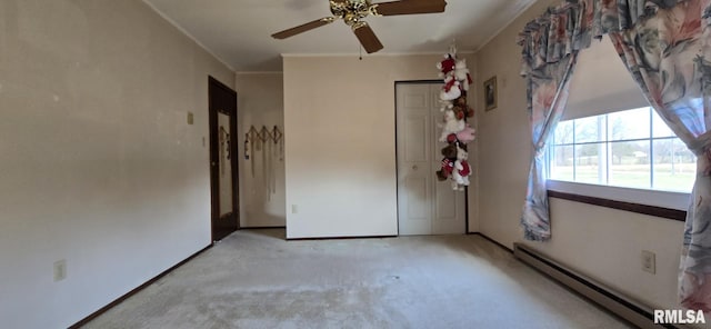 unfurnished bedroom featuring a ceiling fan, ornamental molding, a closet, light carpet, and baseboard heating