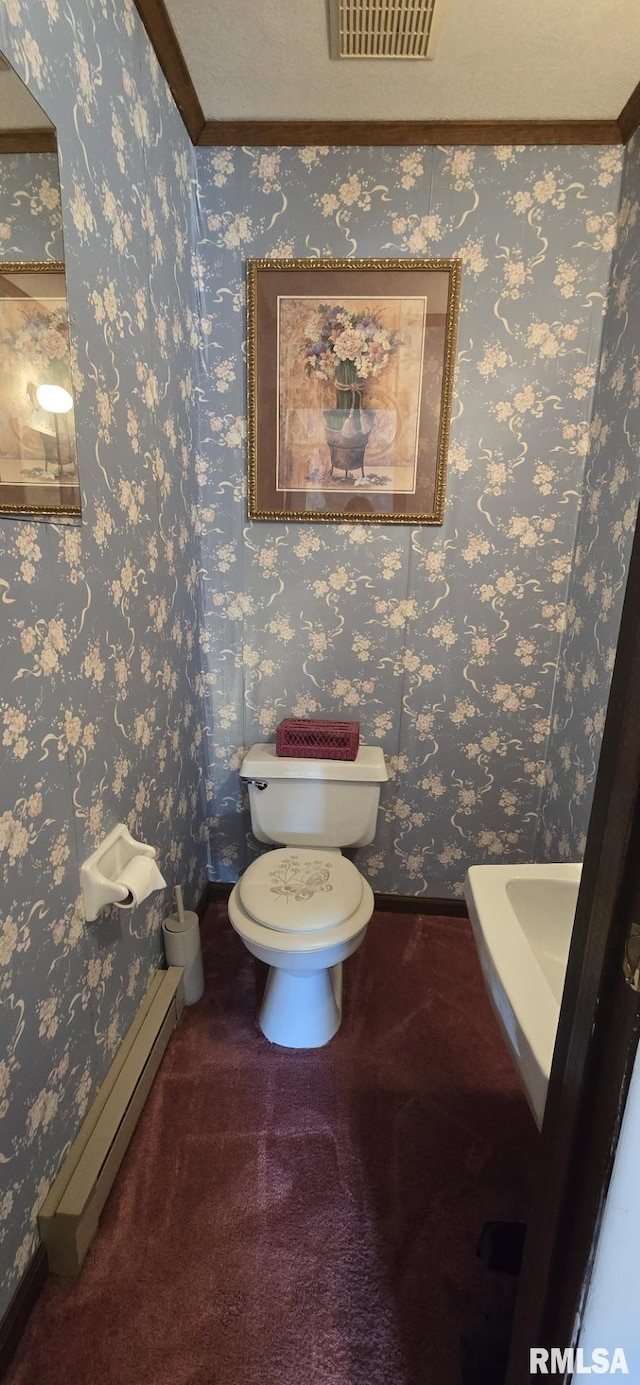 bathroom with visible vents, wallpapered walls, baseboards, toilet, and a baseboard radiator