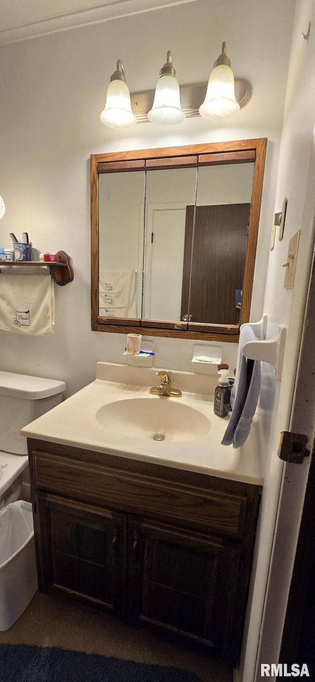 bathroom featuring toilet and vanity