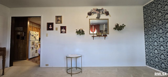 carpeted dining room featuring crown molding and baseboards