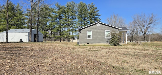 view of home's exterior with an outdoor structure, an outbuilding, and crawl space