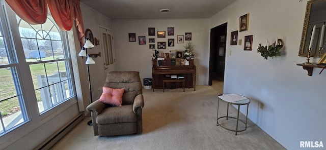 sitting room featuring a baseboard heating unit, carpet, and visible vents