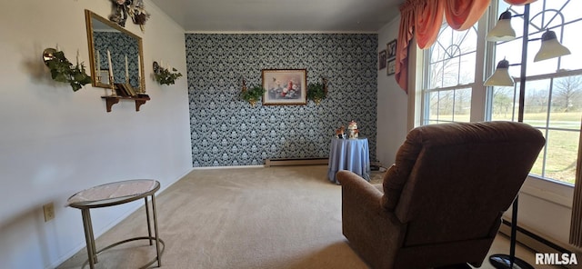 sitting room featuring wallpapered walls, carpet flooring, crown molding, baseboard heating, and an accent wall