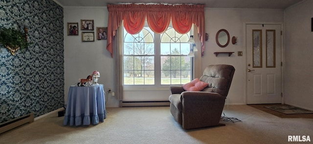 sitting room with a baseboard heating unit, carpet flooring, crown molding, baseboards, and baseboard heating