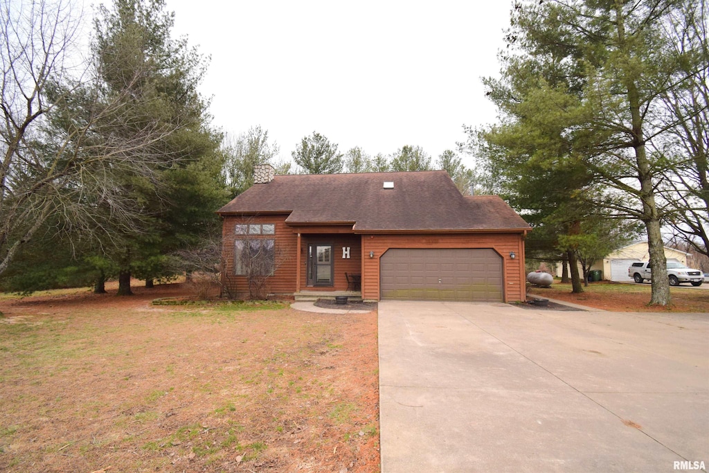 14665 E Windsong Rd, Mount Vernon, IL 62864 - view of front of house featuring a front lawn, roof with shingles, a chimney, a garage, and driveway