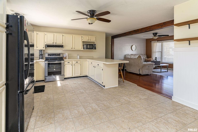 kitchen featuring under cabinet range hood, stainless steel electric stove, open floor plan, freestanding refrigerator, and a peninsula