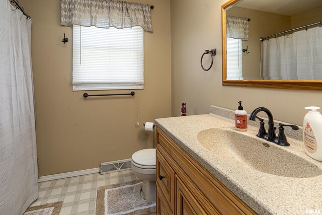 full bathroom with vanity, baseboards, visible vents, tile patterned floors, and toilet