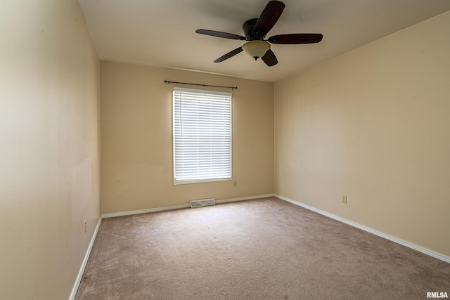 unfurnished room featuring visible vents, baseboards, carpet, and ceiling fan