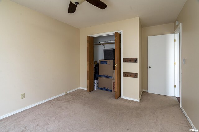 unfurnished bedroom with baseboards, carpet floors, and a ceiling fan