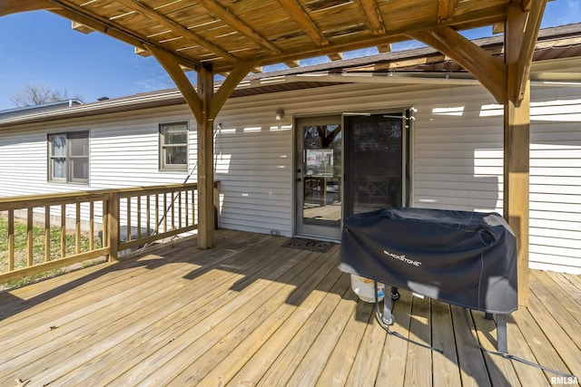 wooden terrace featuring a grill