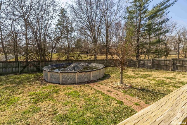 view of yard with a fenced in pool and a fenced backyard