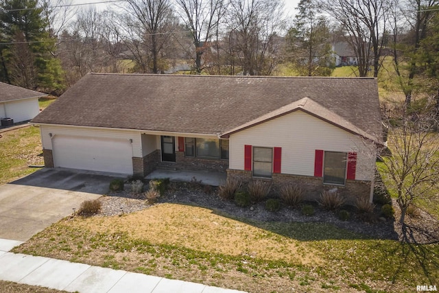 single story home with driveway, a front lawn, brick siding, and an attached garage