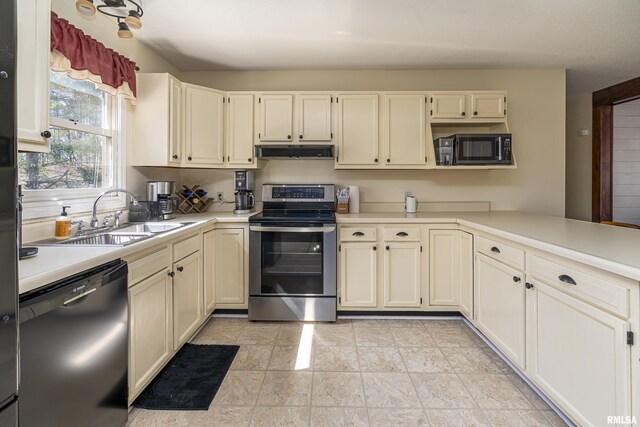 kitchen featuring black appliances, light countertops, under cabinet range hood, and a sink