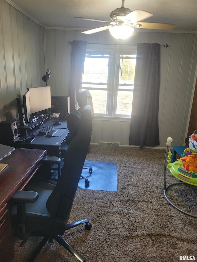 home office with a ceiling fan, carpet flooring, and crown molding