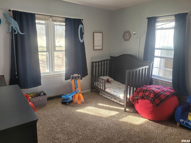 carpeted bedroom featuring baseboards