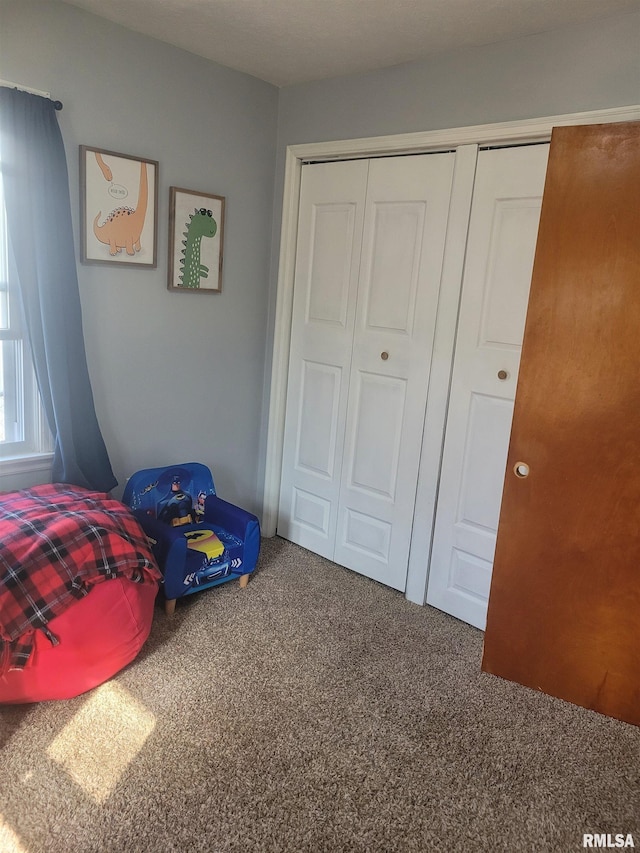 carpeted bedroom with a closet