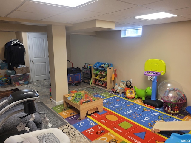 rec room with a paneled ceiling