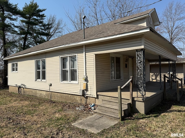 view of front of house featuring a porch and roof with shingles