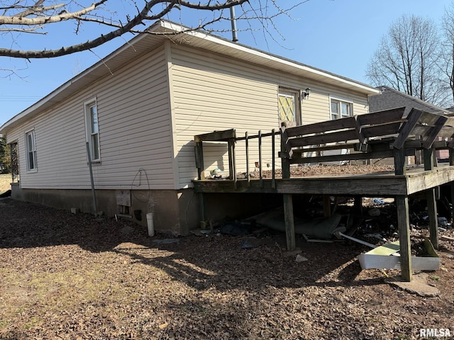 view of side of property with a wooden deck