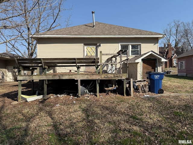 back of property featuring a deck and a shingled roof