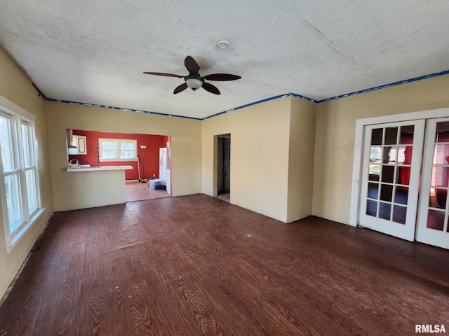 unfurnished living room with french doors, a textured ceiling, wood finished floors, and a ceiling fan