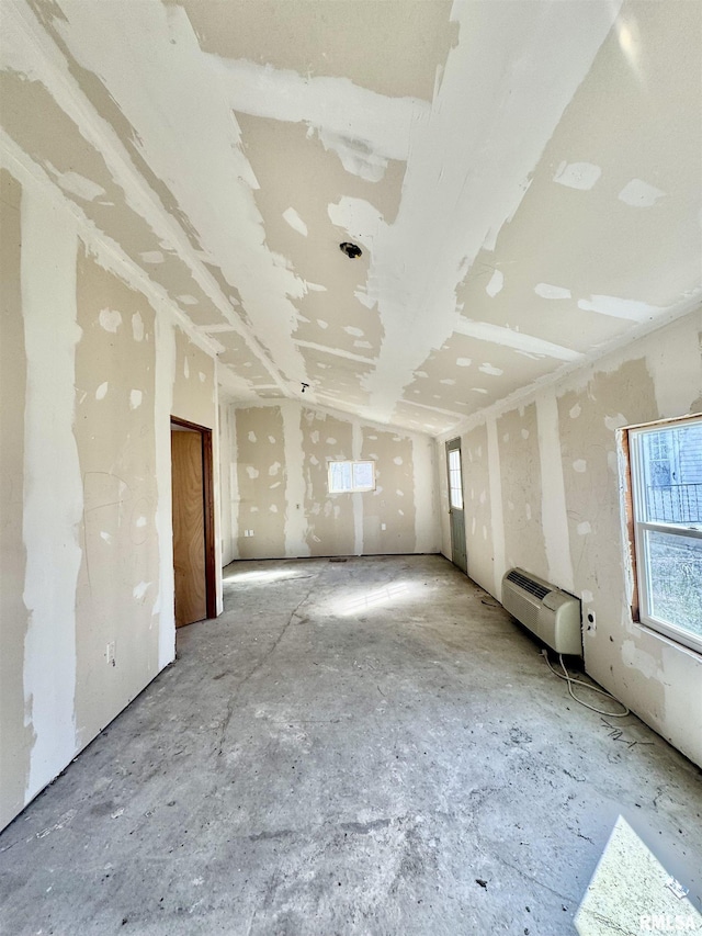 unfurnished room featuring a wall mounted air conditioner