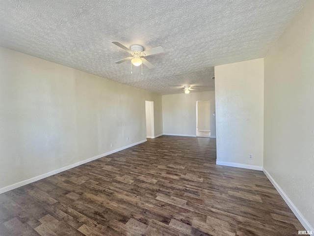 unfurnished room featuring dark wood finished floors, a textured ceiling, baseboards, and ceiling fan